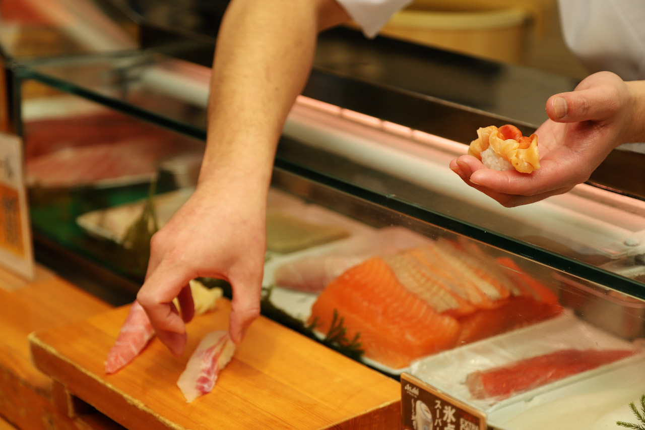 Sushi lined up in clogs